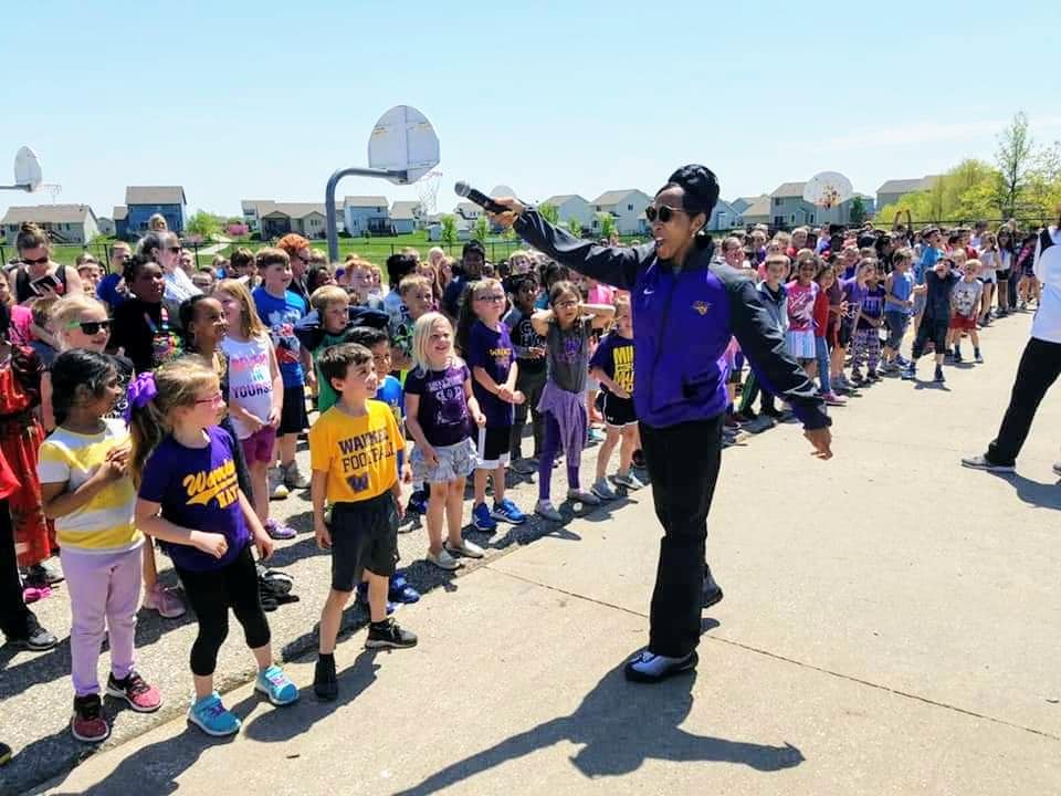 Tanya Warren fires up the students during a school visit while on the Panther Caravan. 